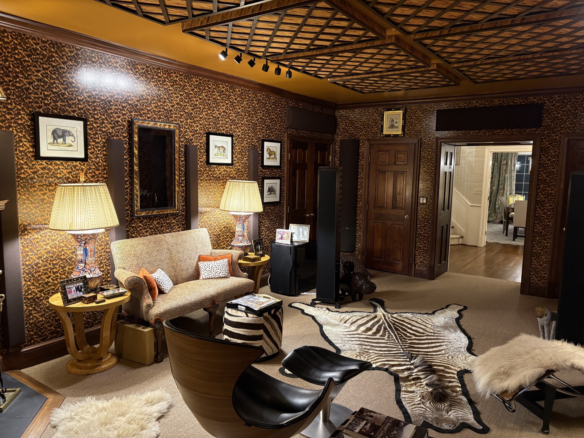 Acoustically treated hi-fi listening room with floor-standing speakers and layered furnishings