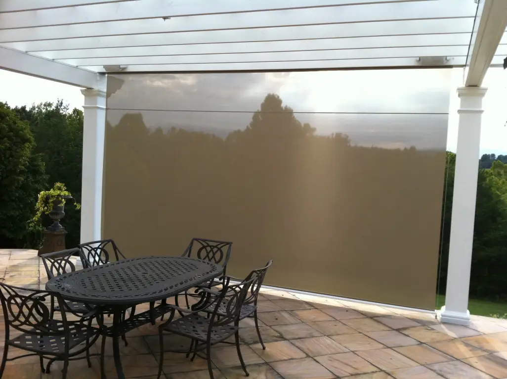 Patio dining area with semi-transparent sunscreen deployed
