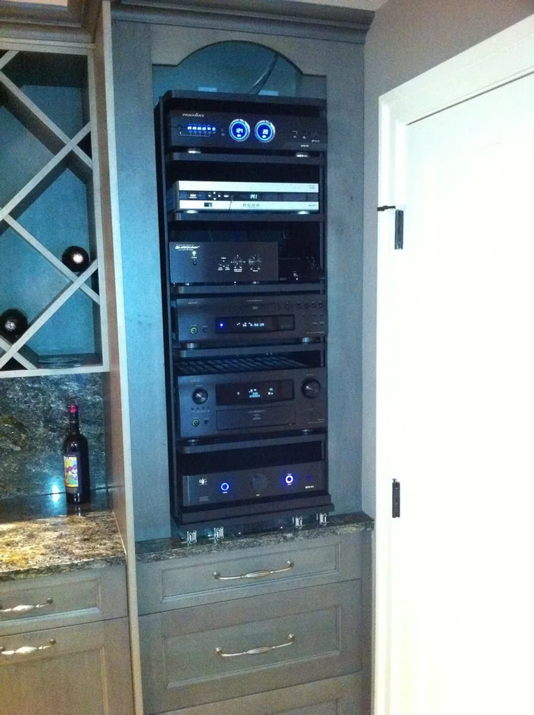 Custom pull-out equipment rack built into a bar area